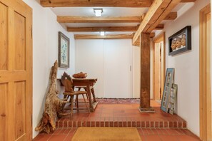 A wooden interior with a dining table, chairs, and a rustic decor.