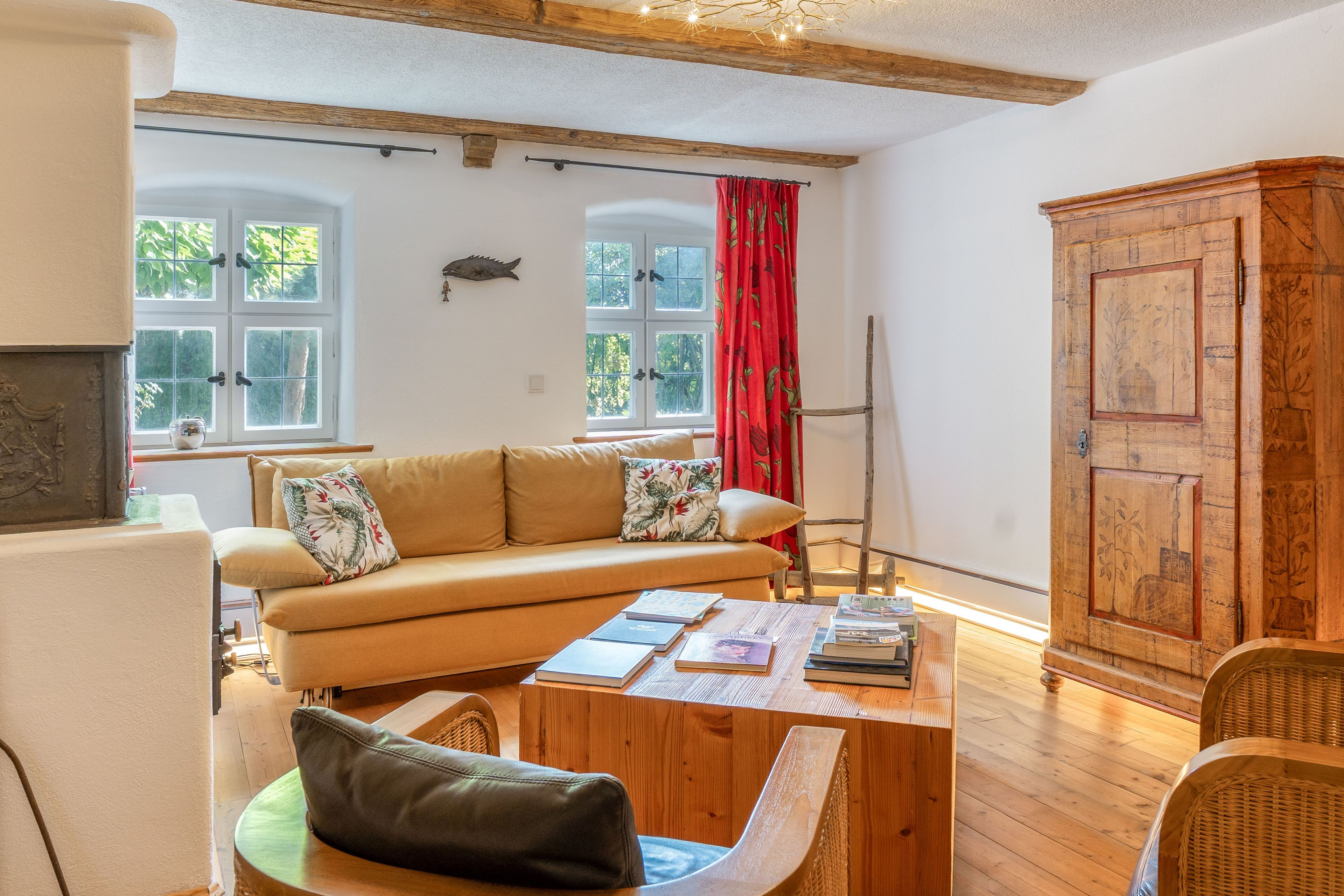 A cozy living room with a sofa, a wooden coffee table, and a cabinet.
