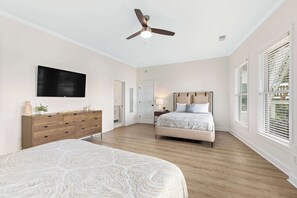 A bedroom with two beds, a ceiling fan, a TV, a dresser, and a window with blinds. - Lake Lyfe Oconee - Game Room, Dock, Firepit (Eatonton)