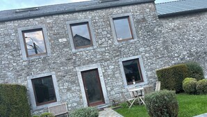 A stone building with multiple windows and a paved entrance. - Room-private Room With Shared Bathroom (Clavier)