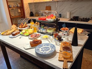 A buffet table with various food items and condiments.