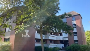 A multi-story building with a sign reading 'Seeadler.'