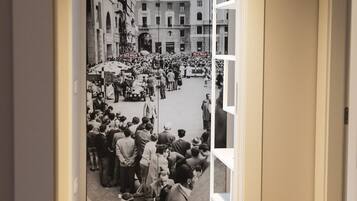 A hallway with a black and white photograph of a crowded street scene.