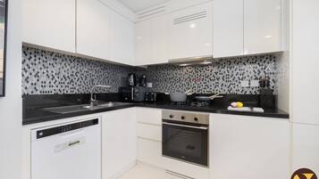 Deluxe Apartment, Balcony, City View | Private kitchen | Electric kettle, toaster, high chair, freezer