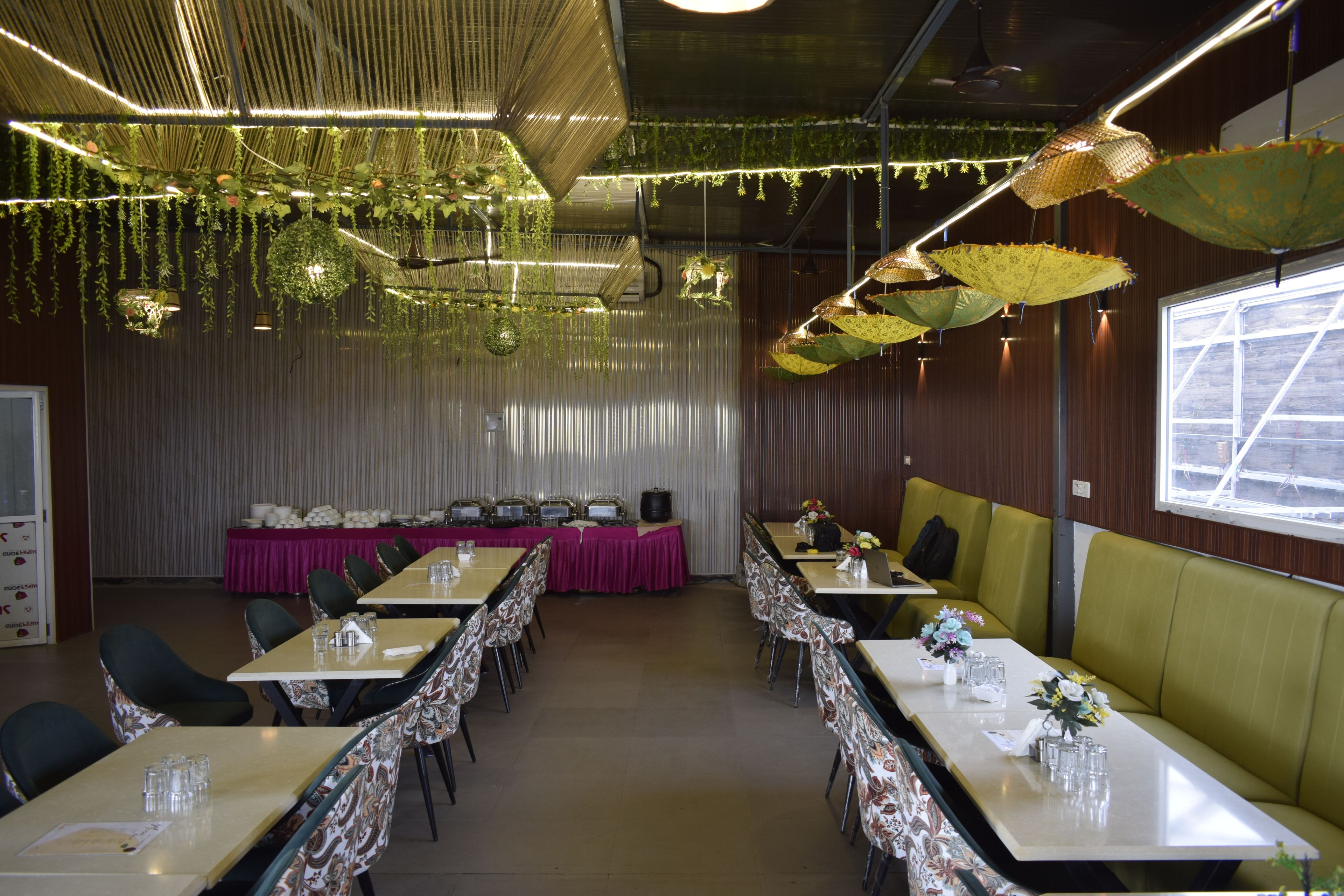 A conference room with tables, chairs, and a buffet setup.
