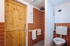 Double Room, Courtyard View | Bathroom | Shower, rainfall showerhead, hair dryer, slippers