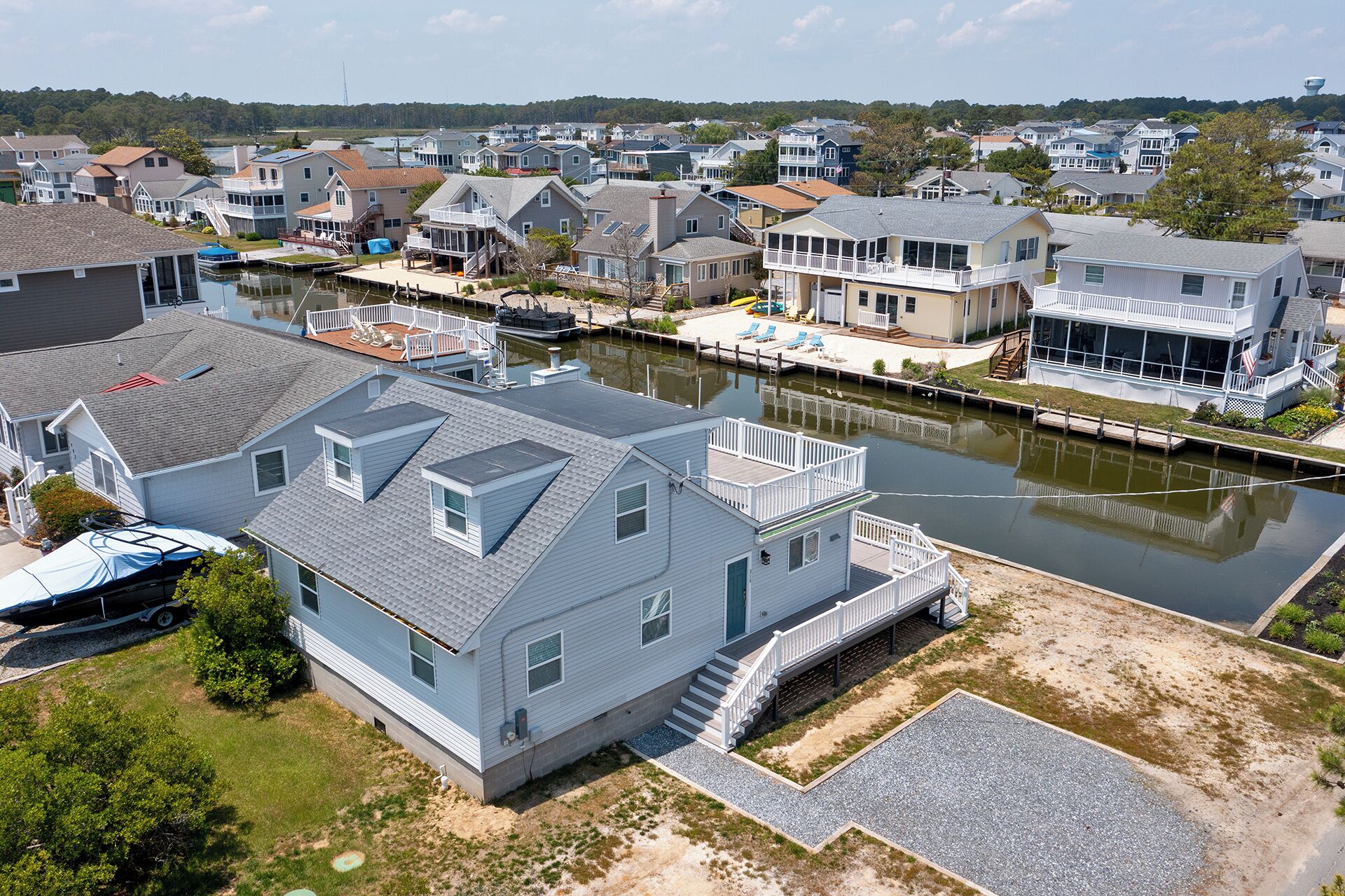 A residential area with houses, a dock, and a canal.