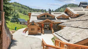 A lodge with a central entrance, multiple roof levels, and a view of a mountainous landscape. - Steps From Ski Lift Hot Tub & Fireplace 3 Bedroom Condo (Park City)