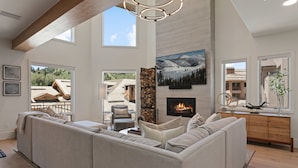A spacious living room with a large sectional sofa, a fireplace, and a stone accent wall. - Steps From Ski Lift Hot Tub & Fireplace 3 Bedroom Condo (Park City)