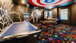 A room with a foosball table, a Star Wars-themed wall, and a Captain America shield mural. - 4312-Prologue (Kissimmee)