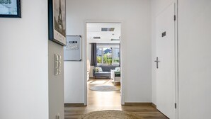 A hallway leading to a living area with a view of the outdoors.