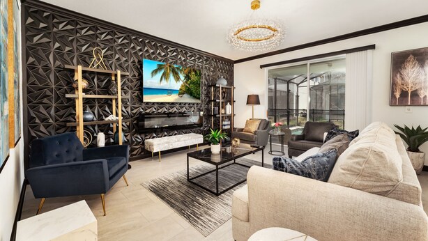 A modern living room with a TV, sofa, coffee table, and decorative wall paneling. - 4359-Rhyme (Kissimmee)