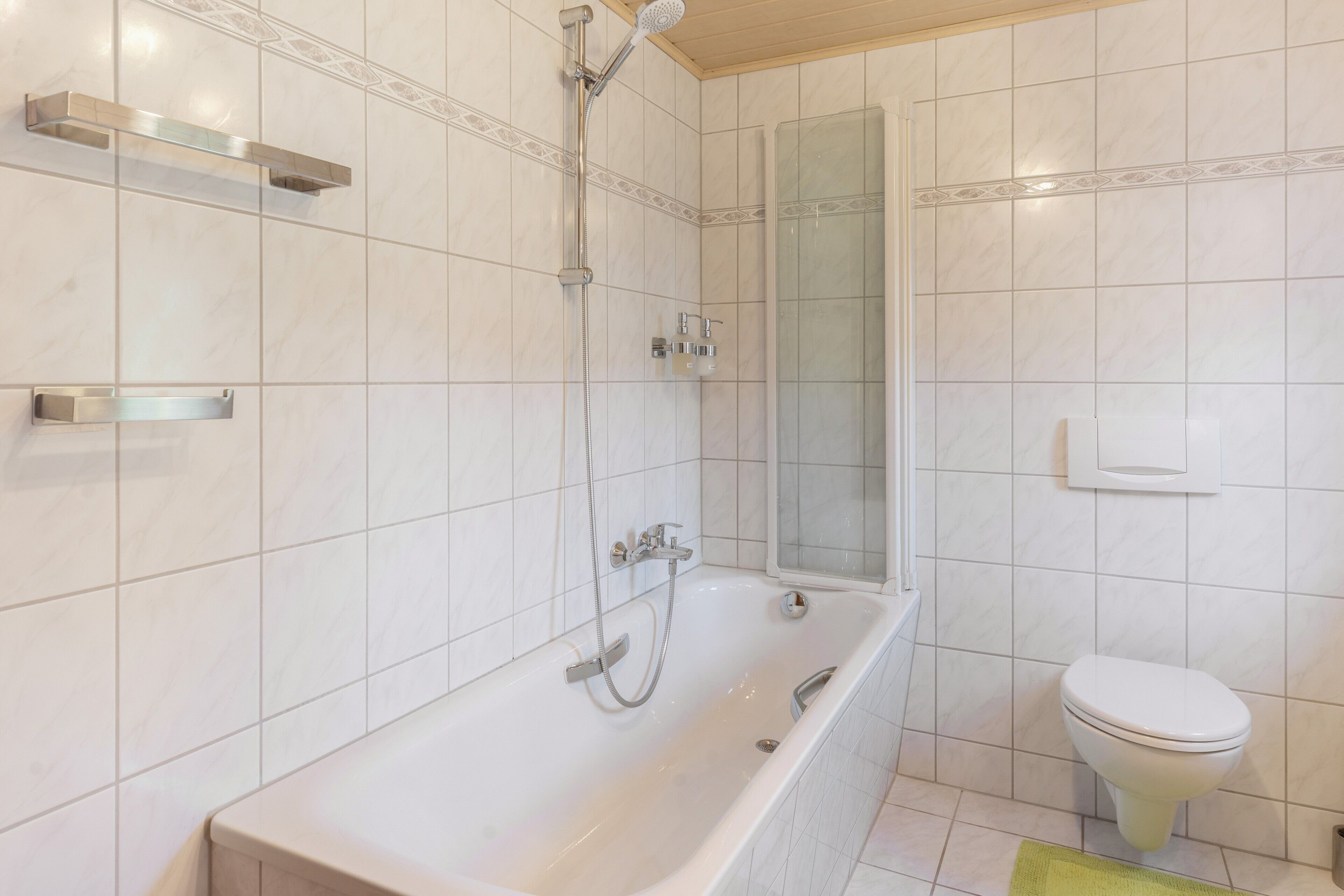 A bathroom with a bathtub, a shower, and a toilet.