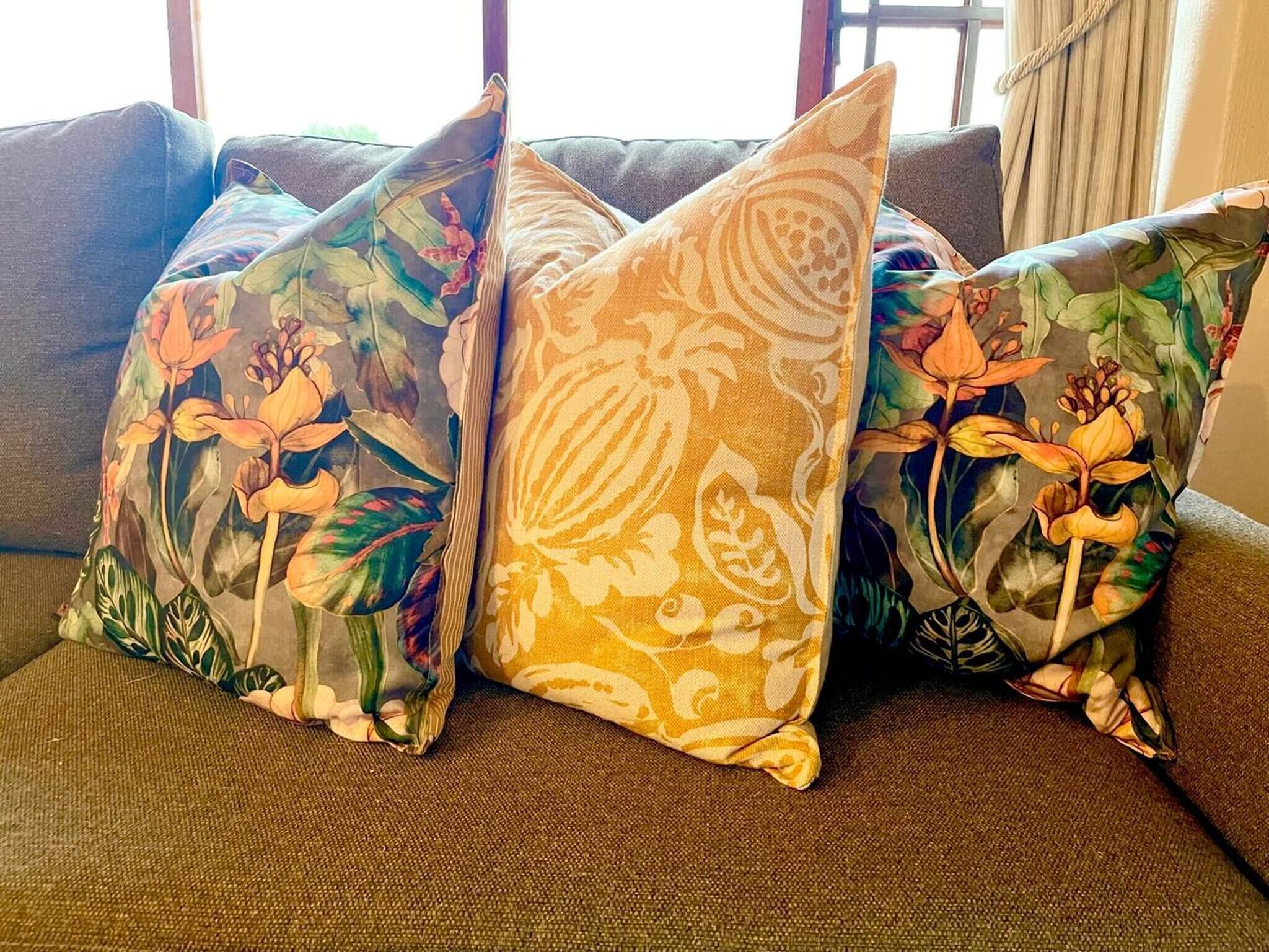 A couch with floral-patterned cushions.