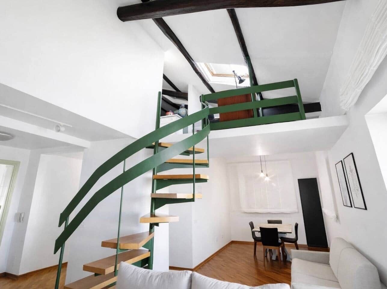 Ein modernes Interieur mit einer Wendeltreppe, einem Essbereich und einem Wohnzimmer.