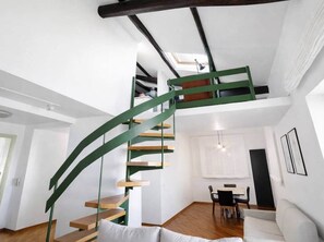 A modern interior with a spiral staircase, a dining area, and a living room. - Villa Belvedere | Lake Bolsena View (Montefiascone)