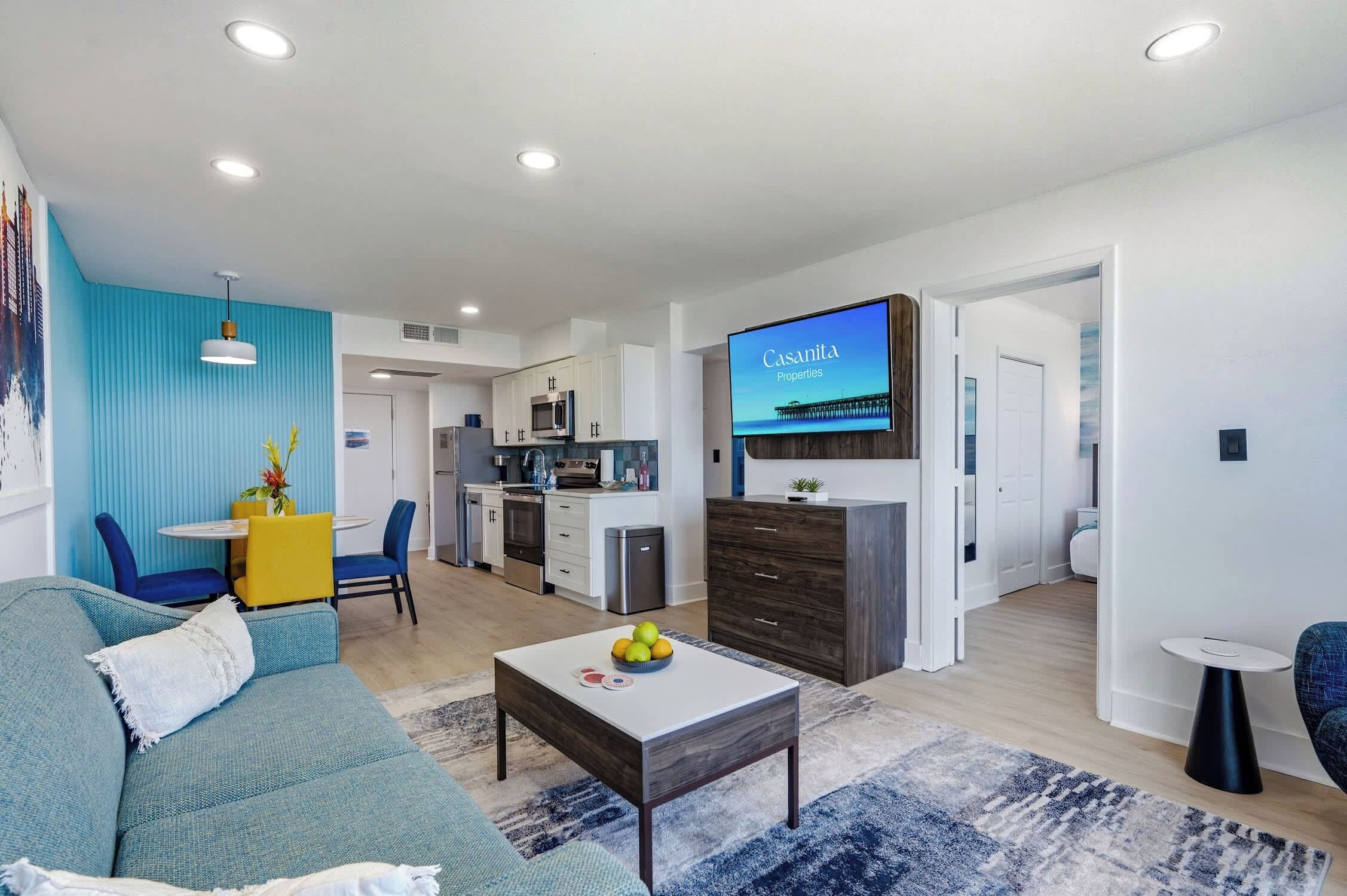 A modern living room with a sofa, coffee table, and a TV displaying 'Casanita Properties'.