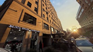 A tall brick building with a storefront labeled "Fashion Milan." - Stylish 2-bedroom Apartment Next to the Republic Sqaure (Yerevan)