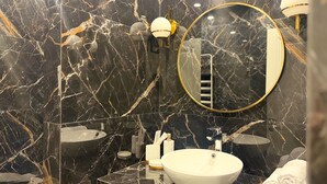 A modern bathroom with a large mirror, a round vanity, and a white sink. - Stylish 2-bedroom Apartment Next to the Republic Sqaure (Yerevan)