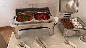 Montaje de bufé con diferentes platillos y utensilios.