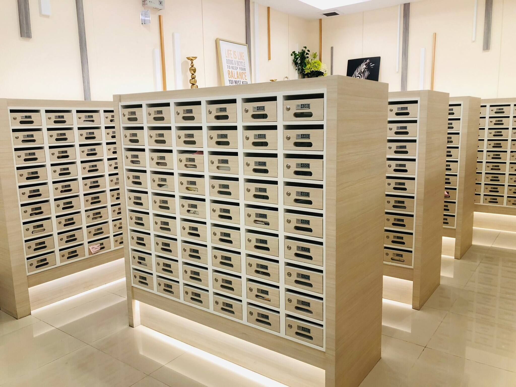 A row of wooden storage units with numbered compartments, likely for guest use.
