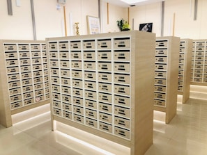 A row of wooden storage units with numbered compartments, likely for guest use. - Room-supalai City Resort Changwattana (Pak Kret)