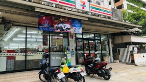 Ein 7-Eleven-Kiosk mit Motorrädern vor der Tür.