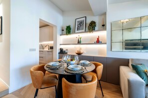 A modern dining area with a round table set for four, surrounded by four chairs. - Genteel Home Campuccio Firenze (Florence)