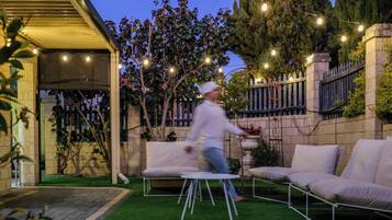 An outdoor patio area with a seating arrangement and string lights.