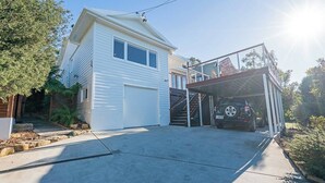 A two-story house with a garage, a covered driveway, and a staircase leading to the upper floor. - Derwent Outlook Gateway to Scenic Trails and Beaches (Mount Nelson)