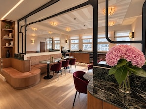 A modern interior with a bar area, seating, and large windows. - 336 Saint Honoré Hotel By Chapitre Collection (Paris)