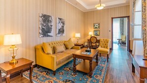 A room with a sofa, armchairs, a coffee table, lamps, and a patterned rug. - Avellino Lakeside Escape (Entebbe)
