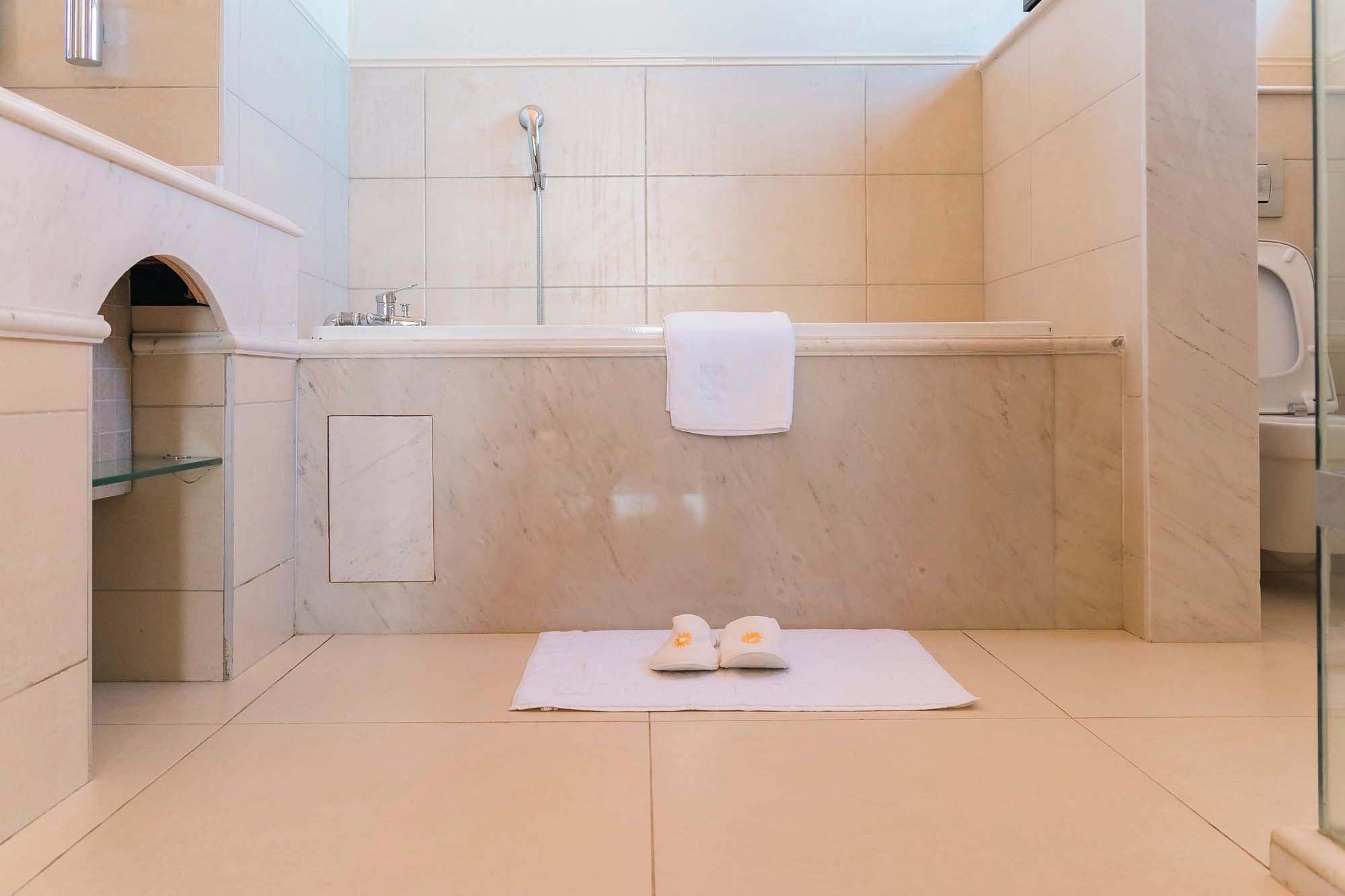 A bathroom with a shower, a sink, and a toilet.
