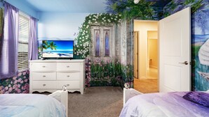 A bedroom with a TV, two beds, a dresser, and a door leading to another room. - 8886-CabotCliffs (Kissimmee)