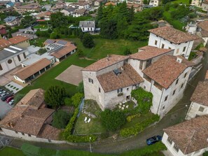 A historic building complex with stone architecture, multiple buildings, and a courtyard.