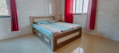 Cozy 1-bedroom farmhouse in serene Badlapur with AC