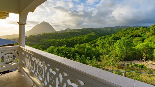 A balcony with a view of a mountainous landscape.
