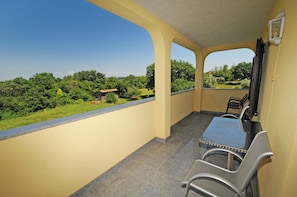 A balcony with a view of greenery and a building in the distance. - CASA Gabrijela - Bijou Apartment - Ideal for couples / couples with small children (Poreč)
