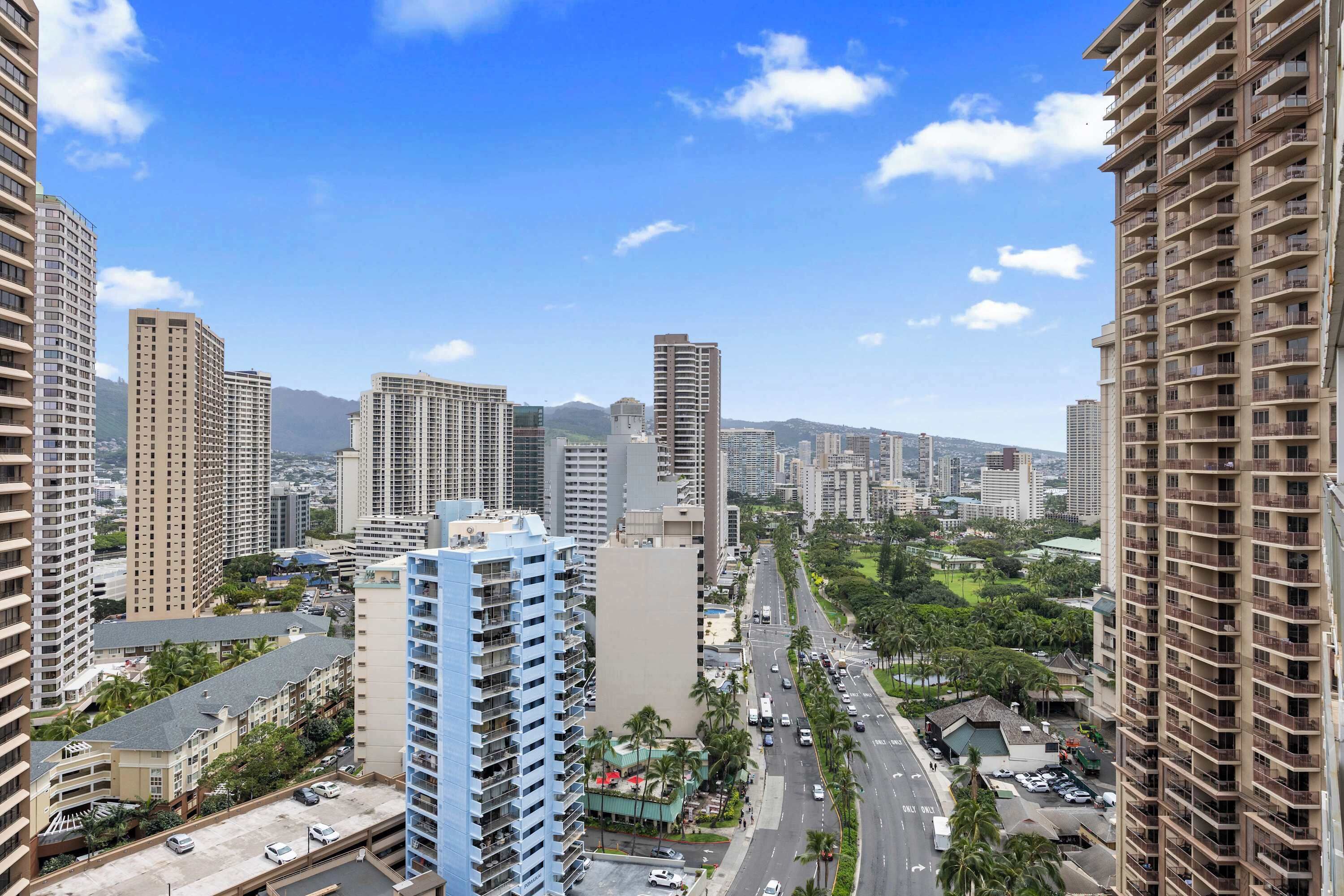 A high-rise urban area with multiple buildings, roads, and greenery.
