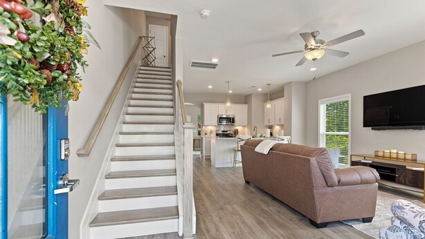 A modern interior with a staircase, a living area with a sofa, a kitchen, and a television. - Stylish Antioch Stay Minutes to Downtown Nashville (Nashville)