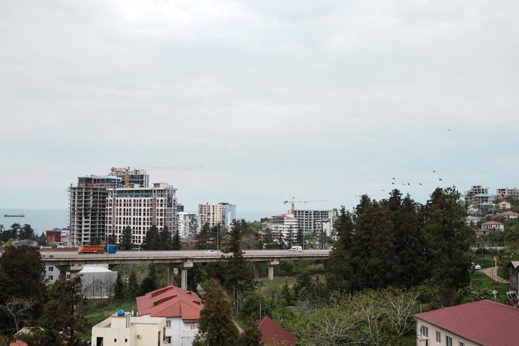 A cityscape with a bridge, buildings, and a body of water.
