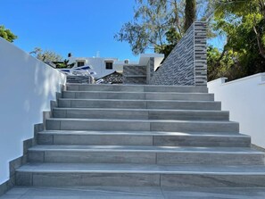 A set of grey stone steps leading up to a building with a white exterior. - A Luxurious 5-Bedroom Kids friendly Private Villa in the Heart of Watamu. (Kilifi)