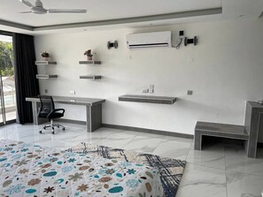 A modern room with a desk, chair, air conditioning unit, and decorative shelves. - A Luxurious 5-Bedroom Kids friendly Private Villa in the Heart of Watamu. (Kilifi)