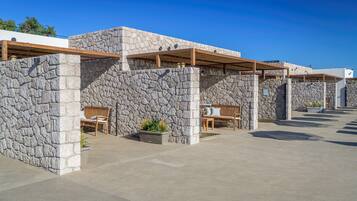 A modern building with stone walls and wooden benches.