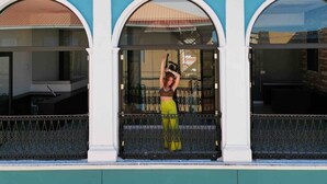 A building with three arched windows and a balcony with a metal railing. - 5.2 Loft • Lobby • Generator • Parking • 2nd Floor (Mayagüez)