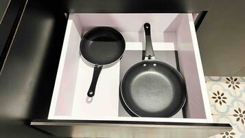 A drawer with two frying pans.