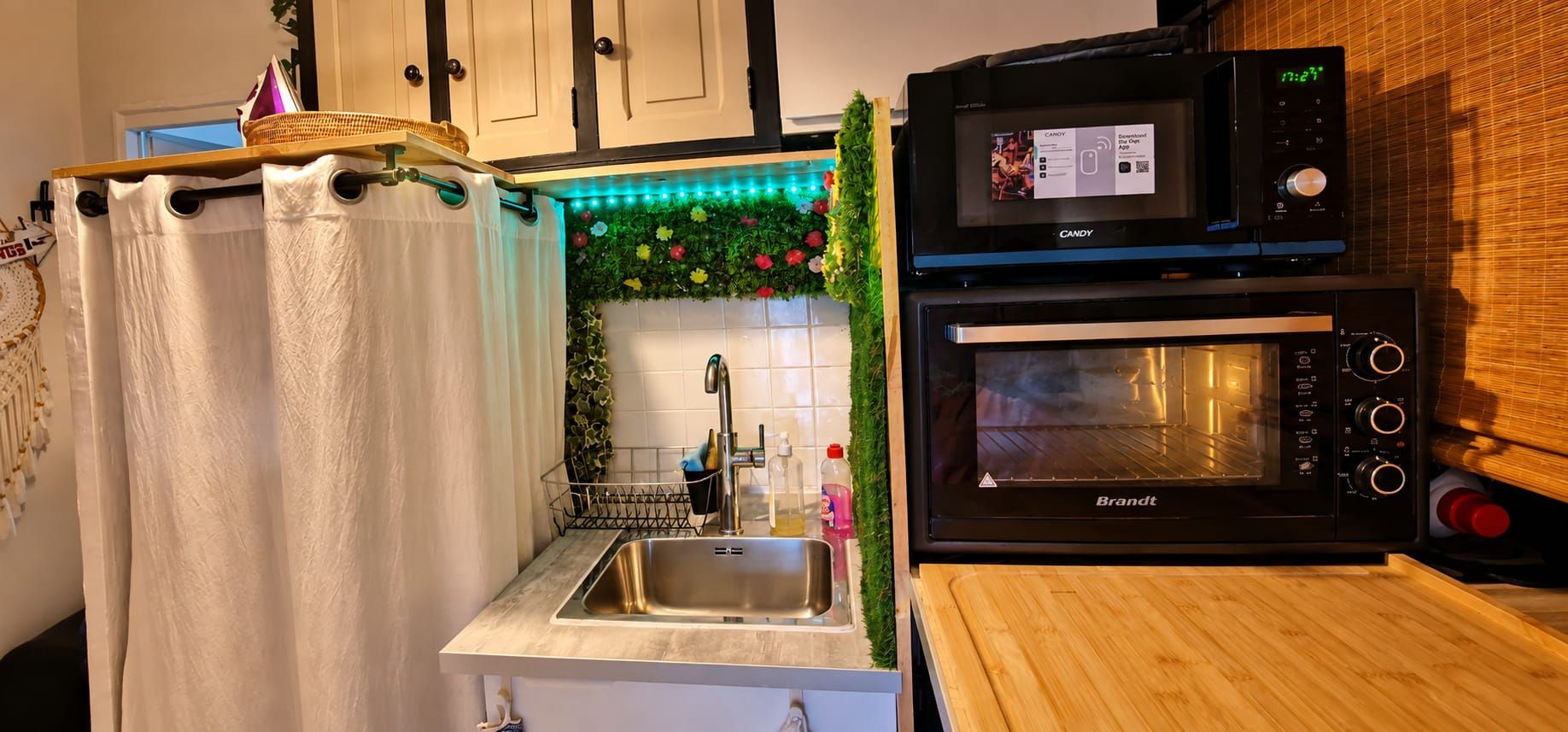 A kitchen with a sink, a microwave, and an oven.
