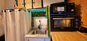A kitchen with a sink, a microwave, and an oven.