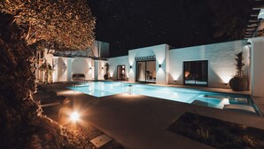 A modern outdoor pool area with a clear view of the pool, a staircase, and a building with large windows. - Fully Staffed Seafront Villa Private Sommelier (Teulada)