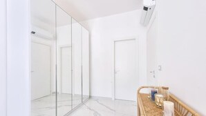 Un baño moderno con cabina de ducha de vidrio, tocador de madera y espejo.
